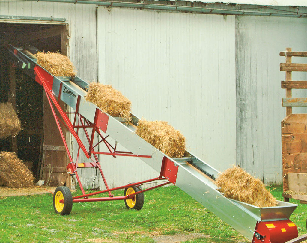agricultural elevator carrying bales of straw